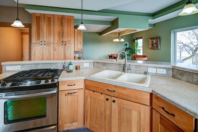 446 County Road Bb, Marshall, WI 53559 - kitchen with stainless steel range with gas cooktop, a chandelier, light countertops, a sink, and hanging light fixtures