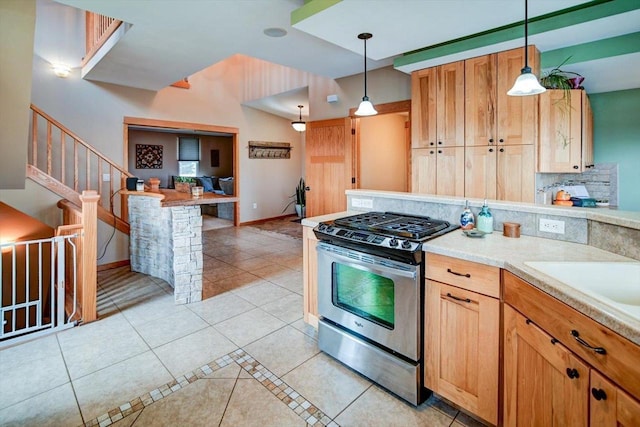 446 County Road Bb, Marshall, WI 53559 - kitchen featuring pendant lighting, light tile patterned flooring, gas stove, light countertops, and decorative backsplash