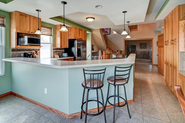 446 County Road Bb, Marshall, WI 53559 - kitchen featuring light tile patterned flooring, light countertops, backsplash, and appliances with stainless steel finishes