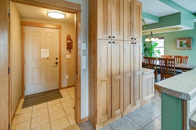 446 County Road Bb, Marshall, WI 53559 - entryway featuring light tile patterned floors, baseboards, and an inviting chandelier