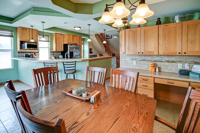 446 County Road Bb, Marshall, WI 53559 - dining area featuring light tile patterned floors, stairway, and a chandelier