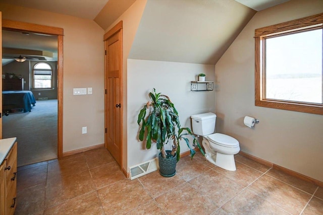 446 County Road Bb, Marshall, WI 53559 - bathroom with toilet, visible vents, baseboards, and vaulted ceiling