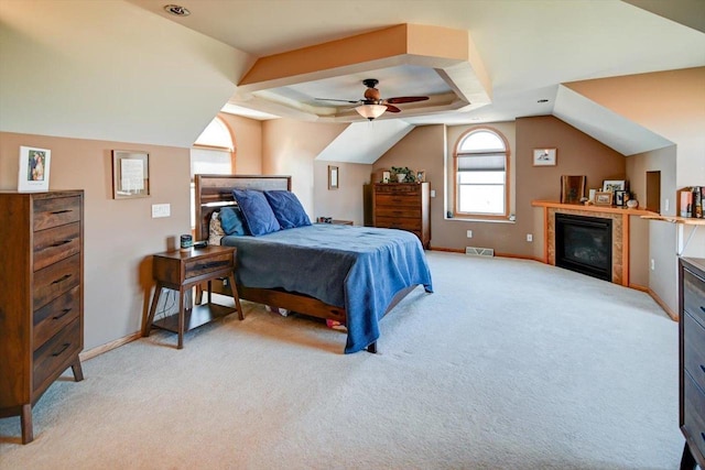 446 County Road Bb, Marshall, WI 53559 - bedroom featuring baseboards, light carpet, visible vents, a tray ceiling, and a tile fireplace