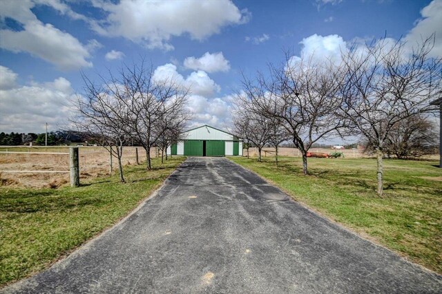 446 County Road Bb, Marshall, WI 53559 - view of front of property featuring aphalt driveway, an outdoor structure, fence, a front lawn, and a garage