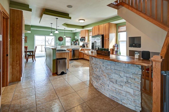 446 County Road Bb, Marshall, WI 53559 - kitchen with a wealth of natural light, a peninsula, a tray ceiling, and appliances with stainless steel finishes