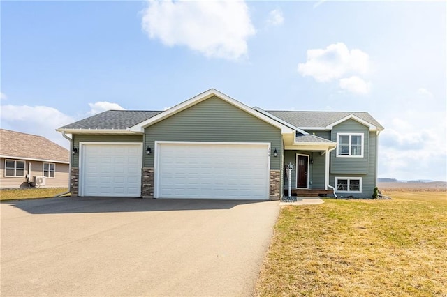306 Dunn St, Colfax, WI 54730 - view of front of house featuring an attached garage, aphalt driveway, and a front yard