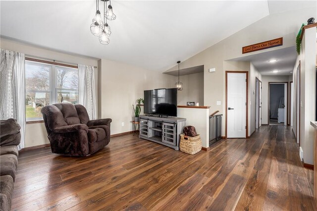 306 Dunn St, Colfax, WI 54730 - living area featuring baseboards, vaulted ceiling, and dark wood finished floors