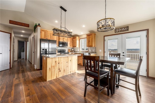 306 Dunn St, Colfax, WI 54730 - kitchen with vaulted ceiling, french doors, backsplash, a kitchen island, and stainless steel appliances