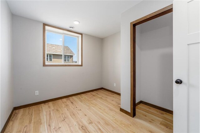 306 Dunn St, Colfax, WI 54730 - unfurnished bedroom featuring baseboards and light wood-type flooring