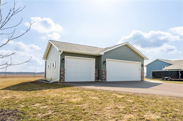 306 Dunn St, Colfax, WI 54730 - view of front of home with a garage, a front lawn, and concrete driveway