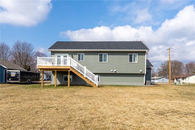 306 Dunn St, Colfax, WI 54730 - rear view of house featuring roof with shingles, stairway, a wooden deck, and a lawn