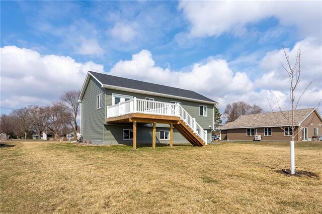 306 Dunn St, Colfax, WI 54730 - back of property with a wooden deck, stairway, and a lawn