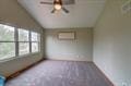 1359 Dianne Ave, Belleville, WI 53508 - interior space featuring a ceiling fan, vaulted ceiling, and an AC wall unit