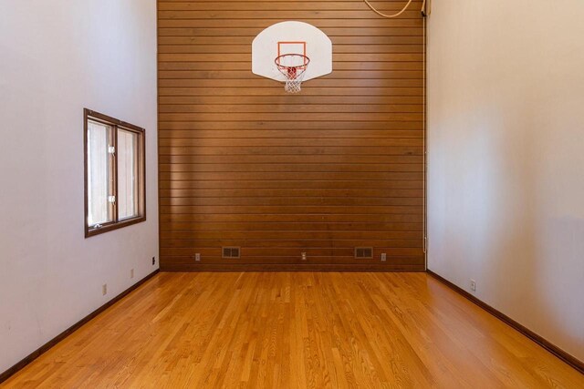2136 White Swan Dr, Oshkosh, WI 54901 - empty room with light wood finished floors, wood walls, and baseboards