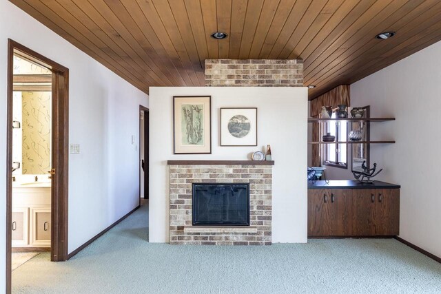 2136 White Swan Dr, Oshkosh, WI 54901 - carpeted living area featuring wooden ceiling, a fireplace, baseboards, and recessed lighting