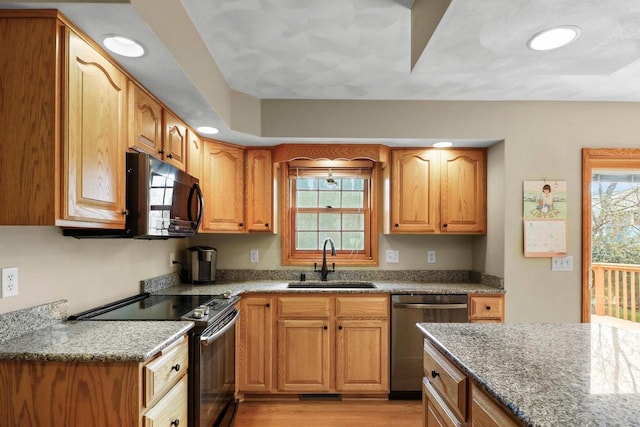 911 Chalfont Dr, Sun Prairie, WI 53590 - kitchen with recessed lighting, light stone counters, a sink, and black appliances