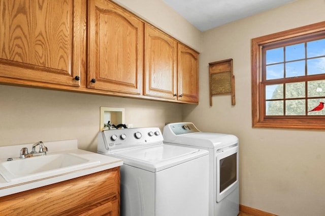 911 Chalfont Dr, Sun Prairie, WI 53590 - washroom with a sink, baseboards, cabinet space, and washing machine and clothes dryer