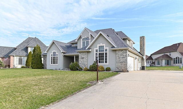 2421 Dover Ln, Mount Pleasant, WI 53406 - traditional-style house with an attached garage, a front yard, concrete driveway, and roof with shingles
