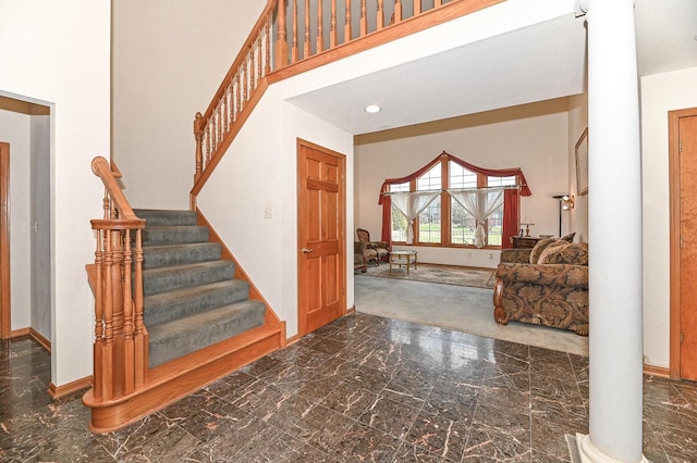 2421 Dover Ln, Mount Pleasant, WI 53406 - entrance foyer with baseboards, decorative columns, marble finish floor, and stairway