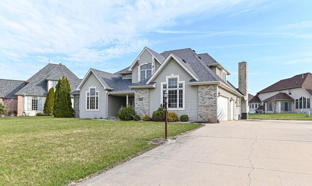 2421 Dover Ln, Mount Pleasant, WI 53406 - traditional-style house with an attached garage, a front yard, concrete driveway, and roof with shingles