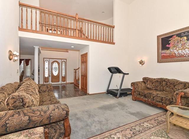 2421 Dover Ln, Mount Pleasant, WI 53406 - living room featuring a high ceiling, baseboards, and decorative columns