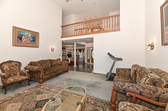 2421 Dover Ln, Mount Pleasant, WI 53406 - living area featuring carpet flooring, baseboards, ornate columns, a ceiling fan, and a high ceiling