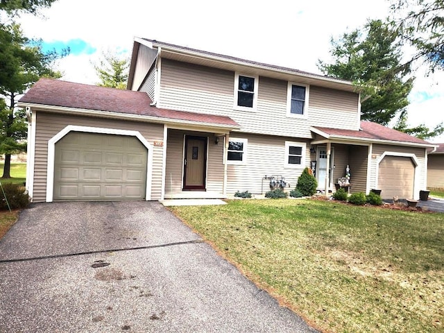 613 Saddle Rdg, Portage, WI 53901 - view of front of home with a front lawn, a garage, and aphalt driveway