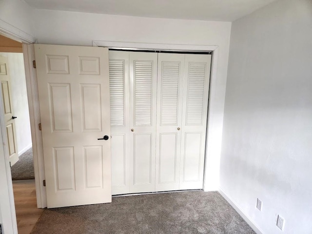 613 Saddle Rdg, Portage, WI 53901 - unfurnished bedroom with a closet, baseboards, and carpet flooring