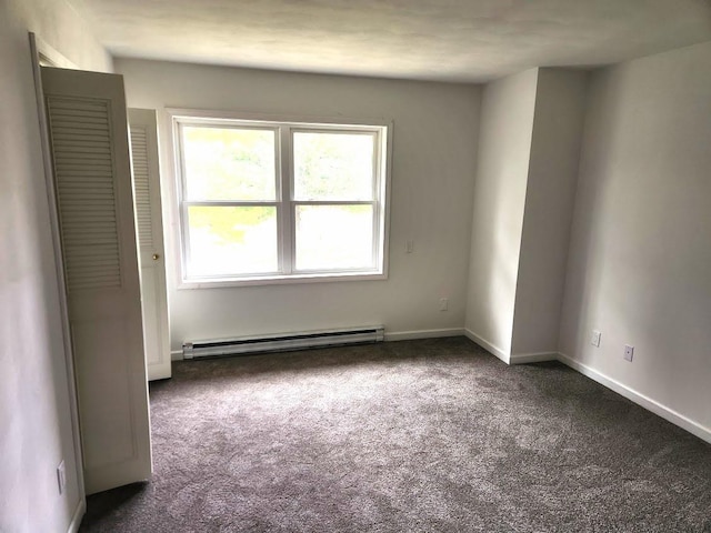 613 Saddle Rdg, Portage, WI 53901 - empty room featuring dark carpet, a baseboard radiator, and baseboards
