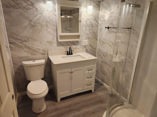 613 Saddle Rdg, Portage, WI 53901 - full bathroom featuring toilet, a stall shower, wood finished floors, and tile walls