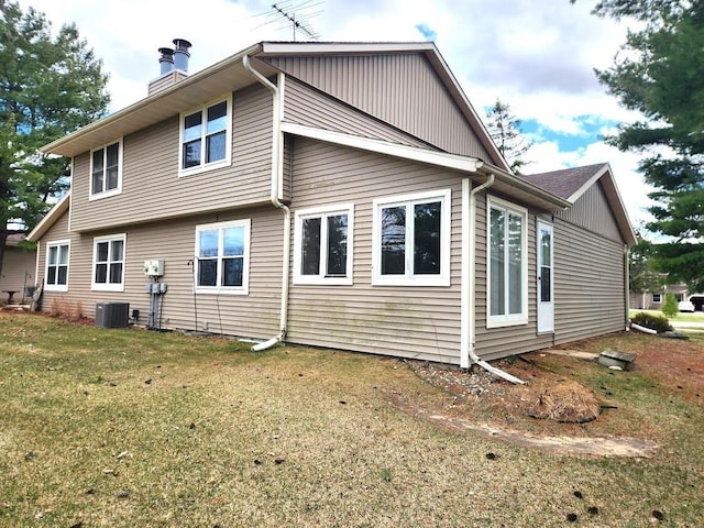613 Saddle Rdg, Portage, WI 53901 - back of house with a yard, central AC, and a chimney