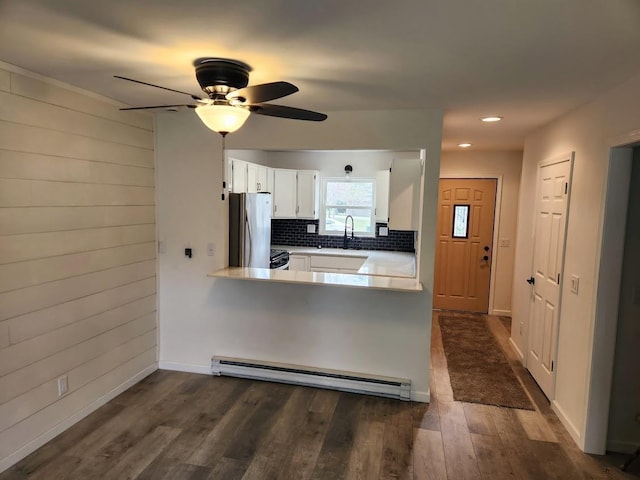 613 Saddle Rdg, Portage, WI 53901 - kitchen featuring dark wood-type flooring, white cabinetry, a baseboard heating unit, a sink, and stainless steel fridge