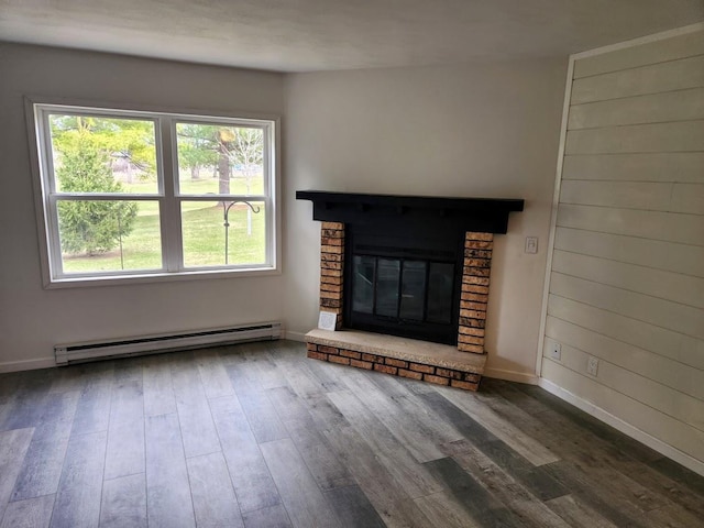 613 Saddle Rdg, Portage, WI 53901 - unfurnished living room featuring baseboards, a baseboard heating unit, wood finished floors, and a fireplace