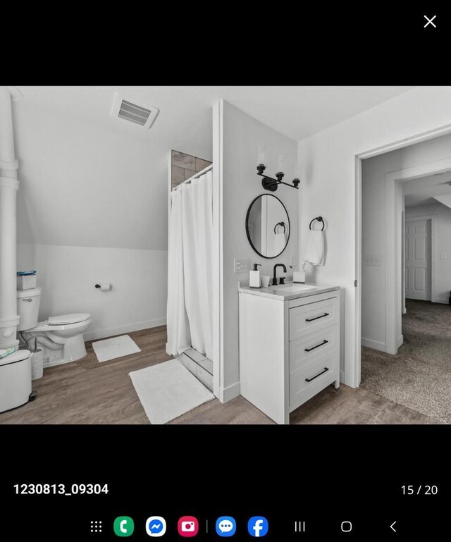 2317 S 9th St, Sheboygan, WI 53081 - bathroom featuring toilet, wood finished floors, vanity, and visible vents