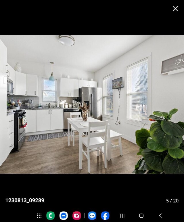 2317 S 9th St, Sheboygan, WI 53081 - kitchen with light wood-style flooring, white cabinets, appliances with stainless steel finishes, and a wealth of natural light