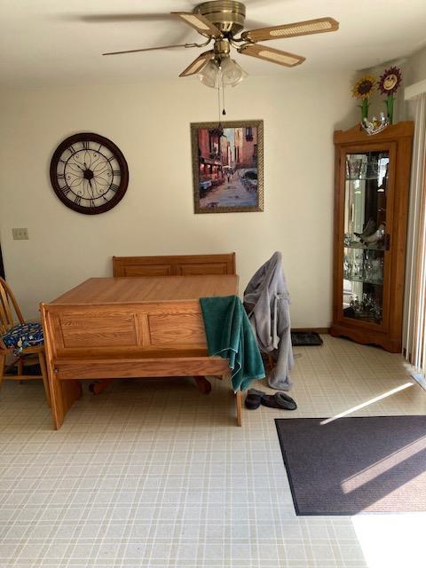 interior space with light carpet and a ceiling fan