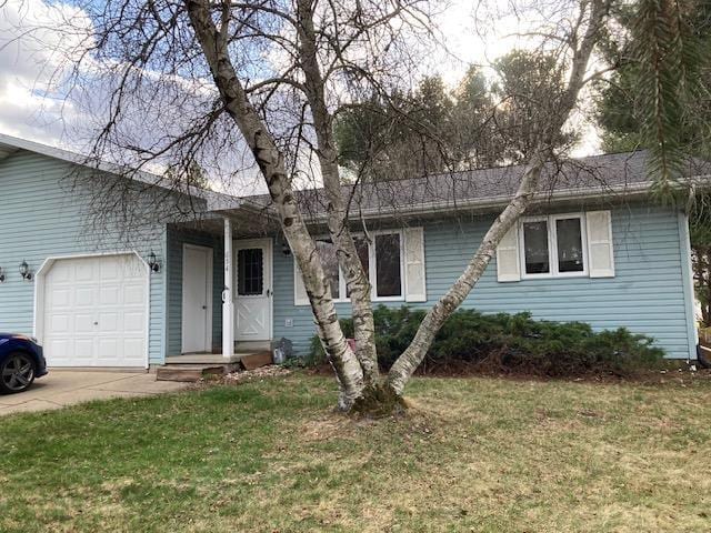 single story home with a garage, a front yard, and driveway