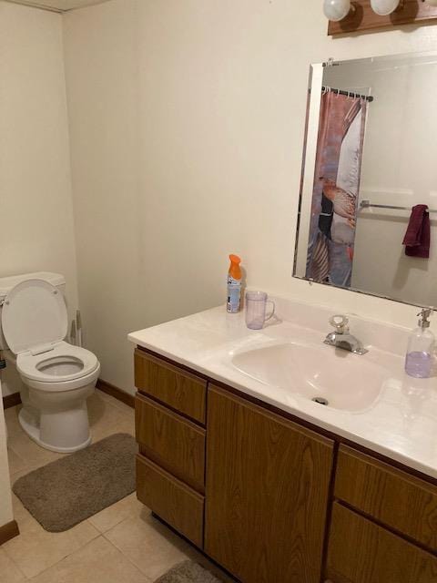 bathroom with toilet, tile patterned floors, vanity, and curtained shower