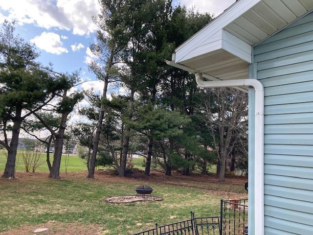 view of yard featuring an outdoor fire pit and fence