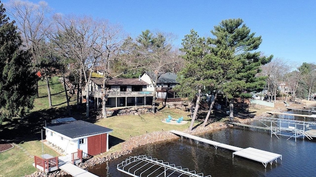 dock area with a deck with water view and a yard