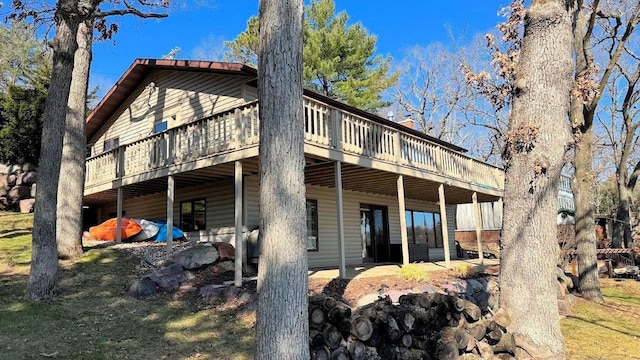 rear view of property featuring a wooden deck