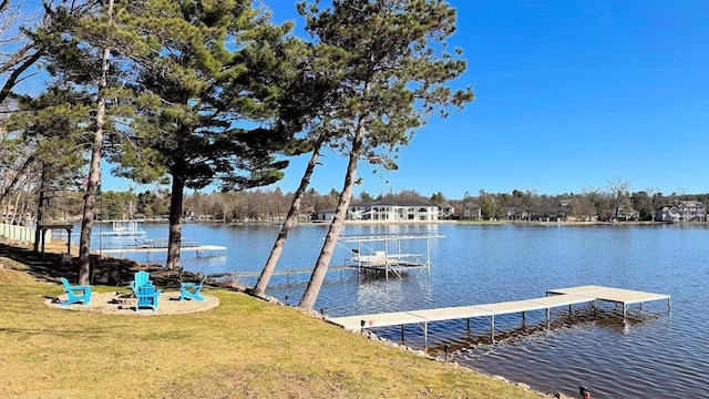 dock area featuring a water view and a yard