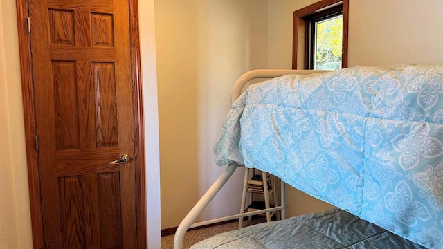 bedroom featuring baseboards and carpet flooring