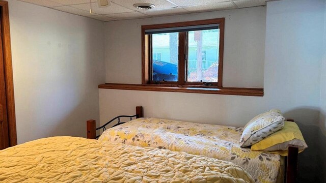 bedroom with visible vents and a drop ceiling
