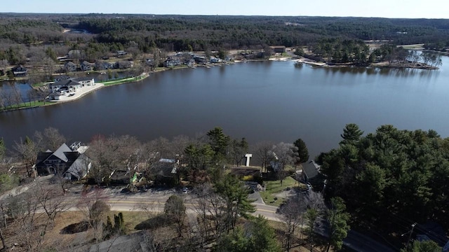 aerial view featuring a wooded view and a water view