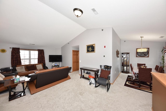 living room with visible vents, light colored carpet, and vaulted ceiling
