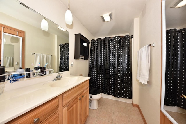 full bathroom featuring toilet, vanity, tile patterned flooring, and visible vents