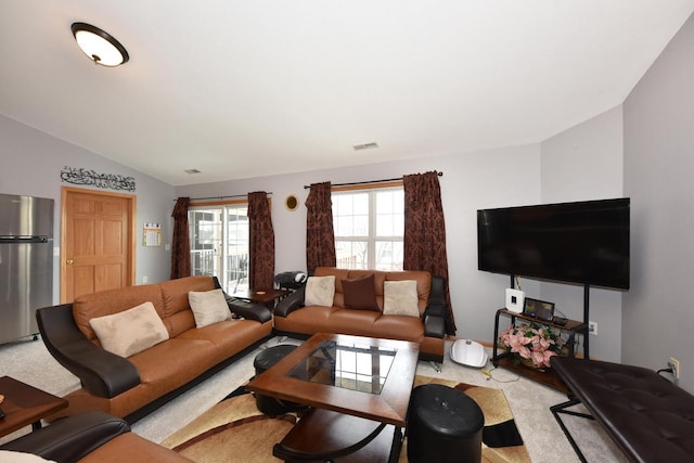living room featuring lofted ceiling and carpet floors