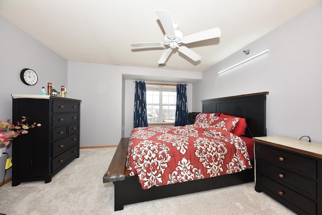 bedroom featuring ceiling fan, light carpet, and baseboards
