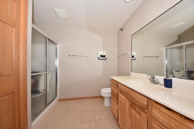 full bath featuring toilet, a stall shower, vanity, and tile patterned flooring